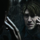 Silent Hill 2 protagonist James examines his face in a mirror.